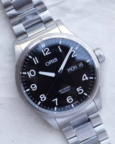 Oris steel watch on black dial and steel bracelet