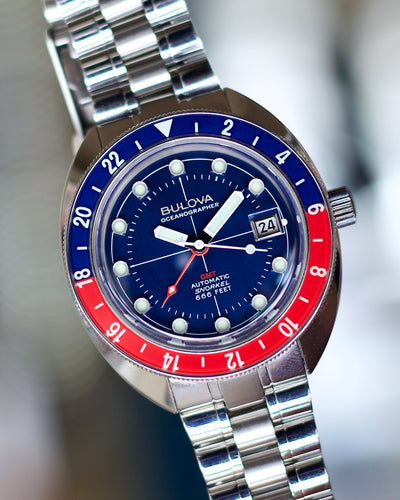 Bulova steel watch with blue and red dial and bezel