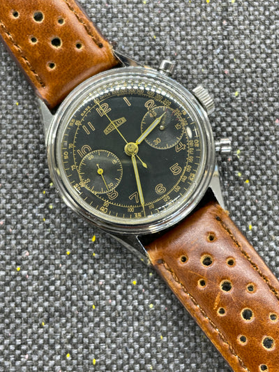 Steel case on black gilt dial and brown leather band