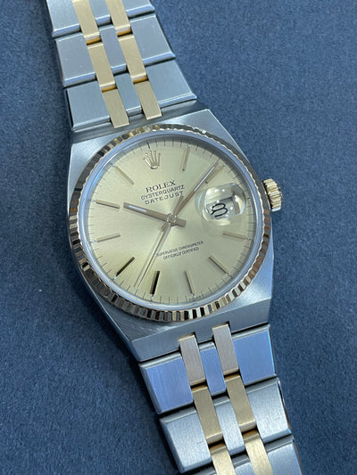 two tone gold and steel wristwatch on gold dial