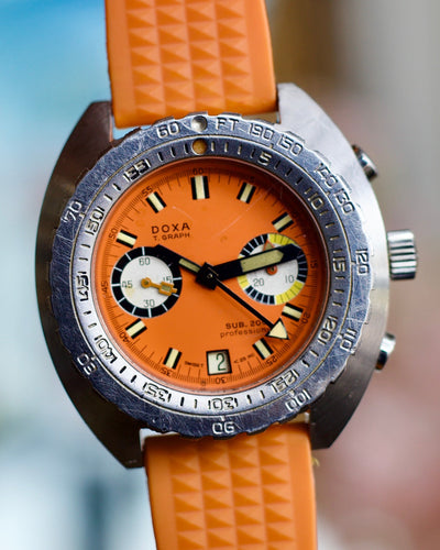 Doxa Watch with orange strap and orange face on a blurred background