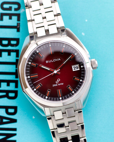 Bulova steel watch with red dial