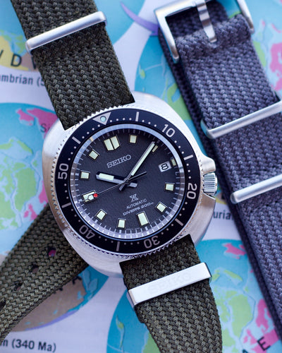 Seiko watch with a dark strap on a map background