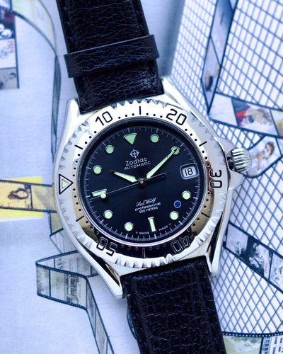 Zodiac watch with black strap on a textured surface