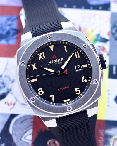 Alpina watch with black dial and rubber strap on a colorful background