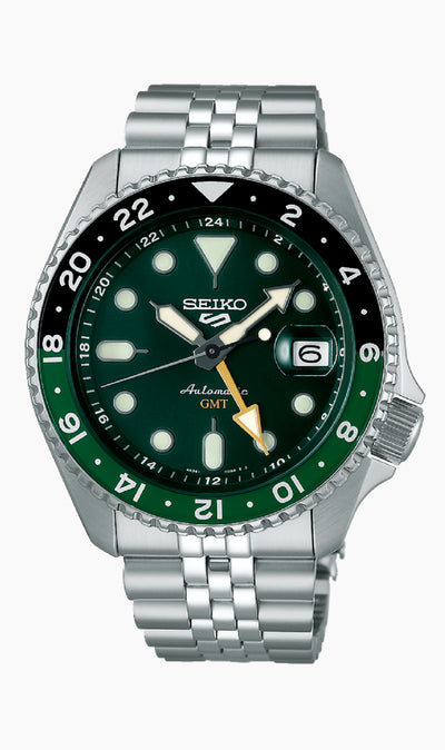 Seiko steel watch on green dial