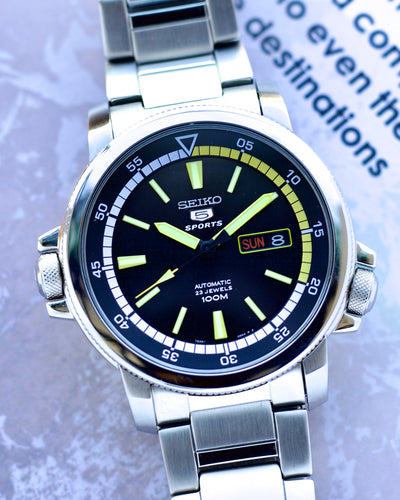 Seiko watch with a silver strap on a blurred background
