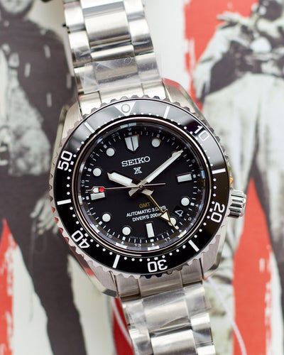 Seiko steel watch with black dial.