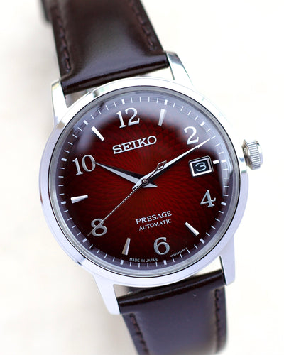 Seiko steel watch with red dial