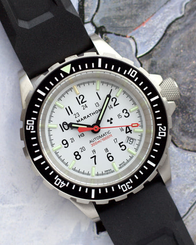Marathon watch with black strap on a textured surface