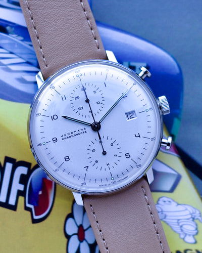 Wristwatch with beige leather strap on a colorful background