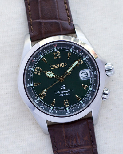 Seiko steel watch with green dial and brown strap 