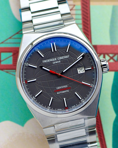Silver Frederique constant watch with a blue and gray face on a colorful background