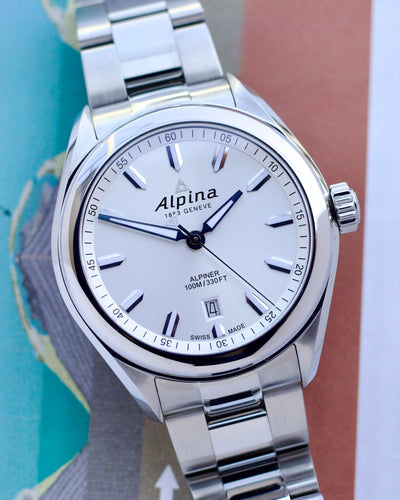 Silver Alpina watch with a white dial on a colorful background