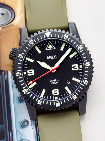 Ares watch with black dial and green strap on a white background