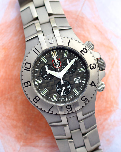  Luminox watch, prominently positioned in the foreground. The watch features a sleek, metallic band and a detailed dial with multiple subdials and a date display.