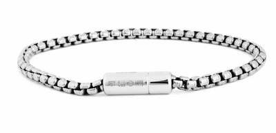 Silver bracelet with a cylindrical clasp on a white background