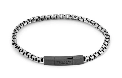 Black and white patterned bracelet with a brand tag on a white background
