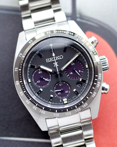 Seiko watch with a silver strap on a blurred background