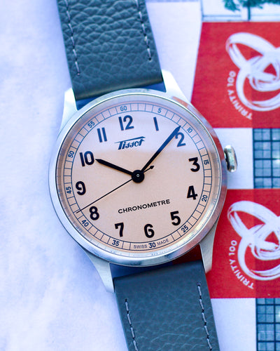 Tissot watch with a blue strap on a white background