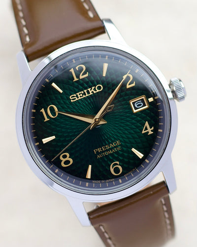 Seiko steel watch with green dial and browns strap