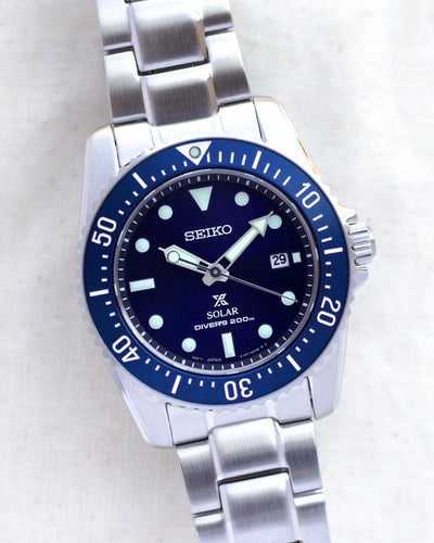 Seiko steel wristwatch on blue dial and steel band