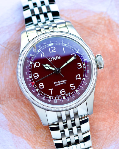 Oris watch with a silver bracelet on a light background