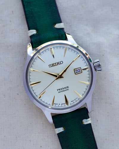 Seiko steel watch on green leather