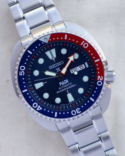 Seiko steel watch with red and blue colors