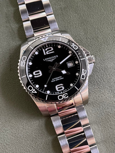 Longines steel watch on black dial and steel bracelet