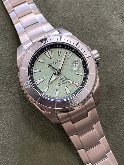 Seiko titanium watch on green dial