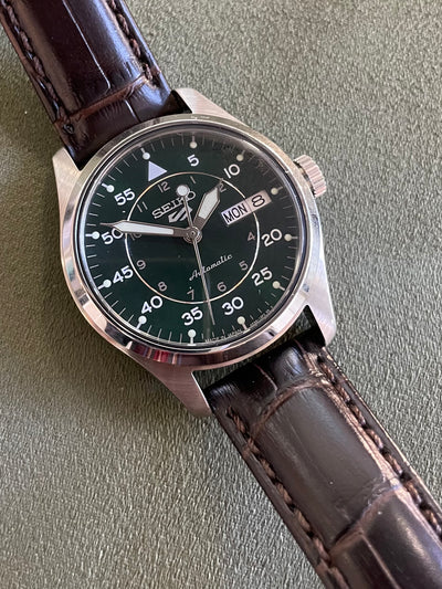 Seiko watch on leather band and green band