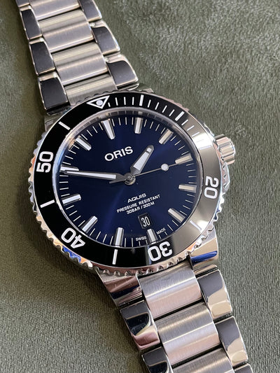Oris steel watch on blue dial