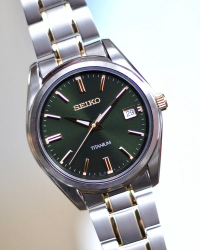 Seiko titanium and gold watch on green dial 