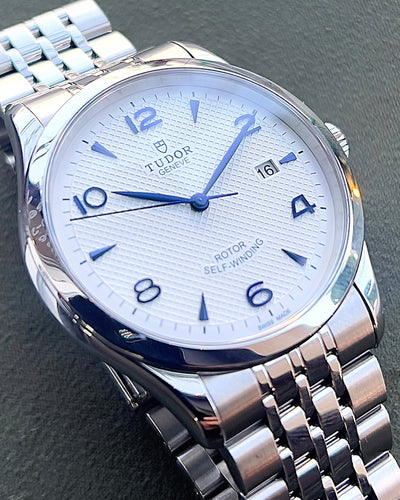 Tudor steel watch on white dial and steel bracelet