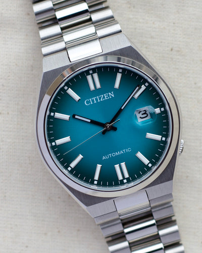 citizen steel watch with teal dial 