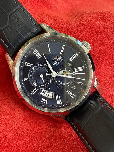 steel watch with blue dial showing multi functions