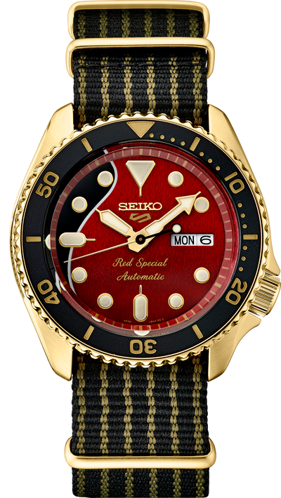 Gold Tone wristwatch with Red dial on black srriped band