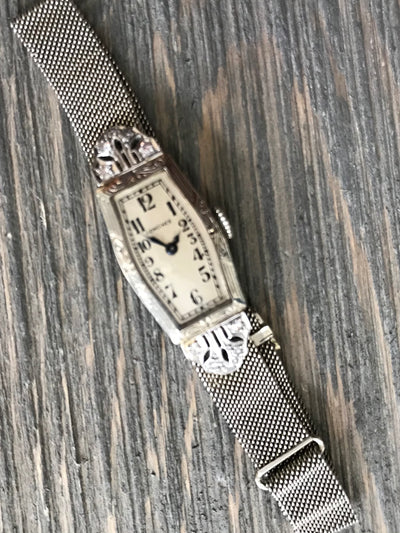 white gold wrist watch with off white dial