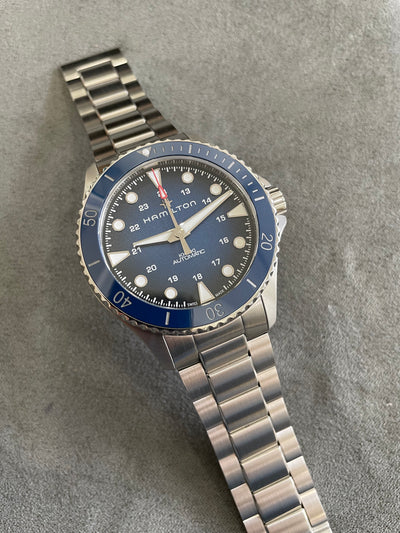 steel wristwatch with blue dial and steel bracelet