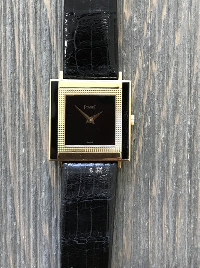 Gold Wrist watch with black dial and black leather band