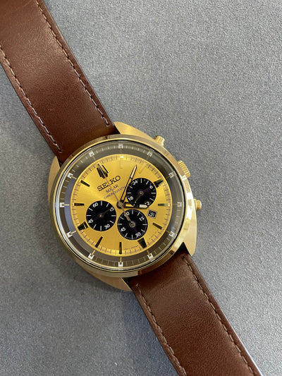 Gold tone chronograph wristwatch on brown band