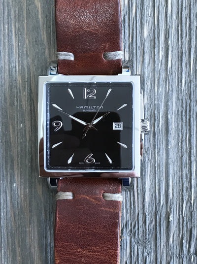 Steel Wrsit watch, black dial and brown leather band